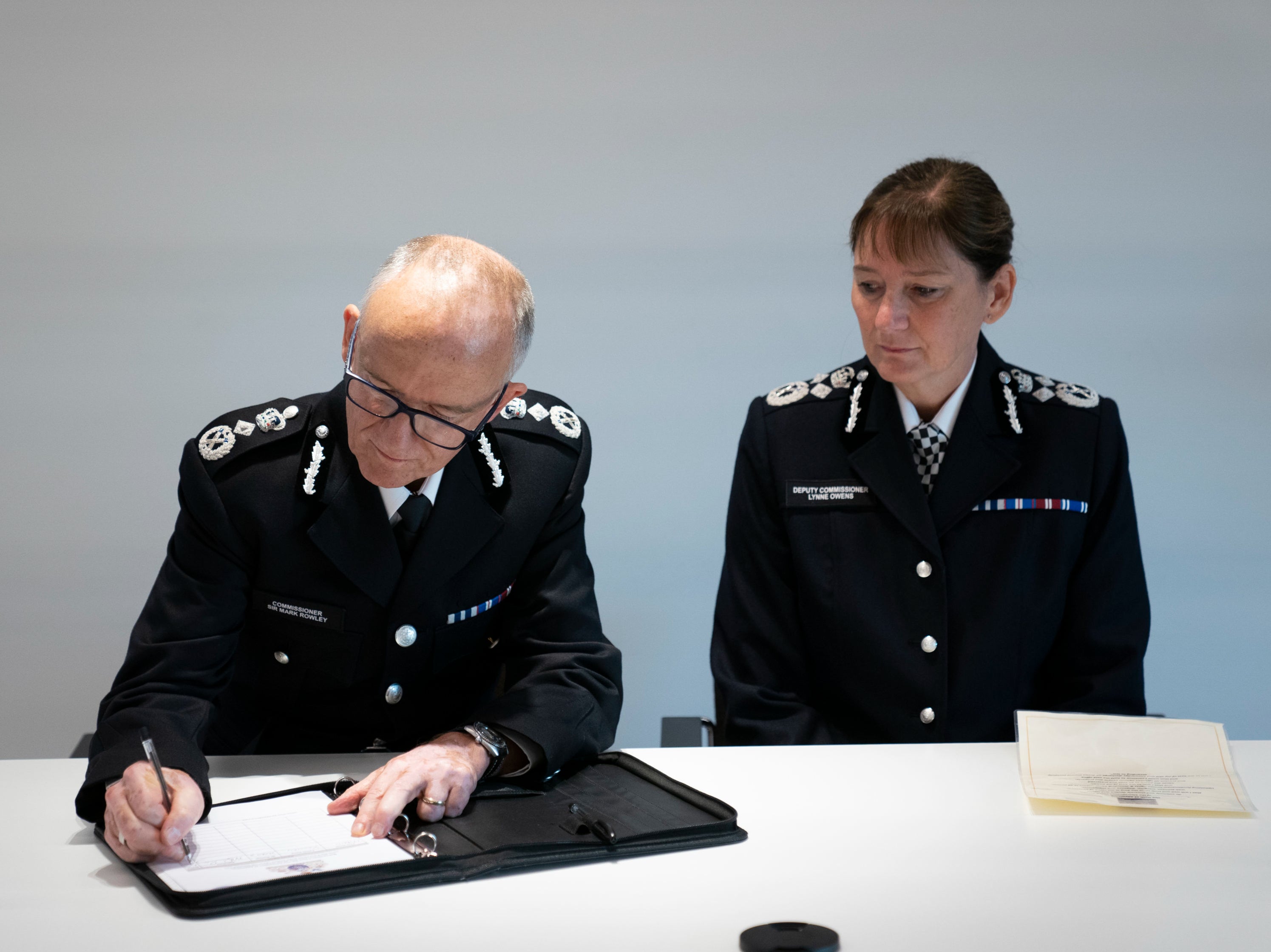 Sir Mark Rowley (left) and Deputy Commissioner Lynne Owens sign the Warrant Register at New Scotland Yard in central London on 12 September 2022