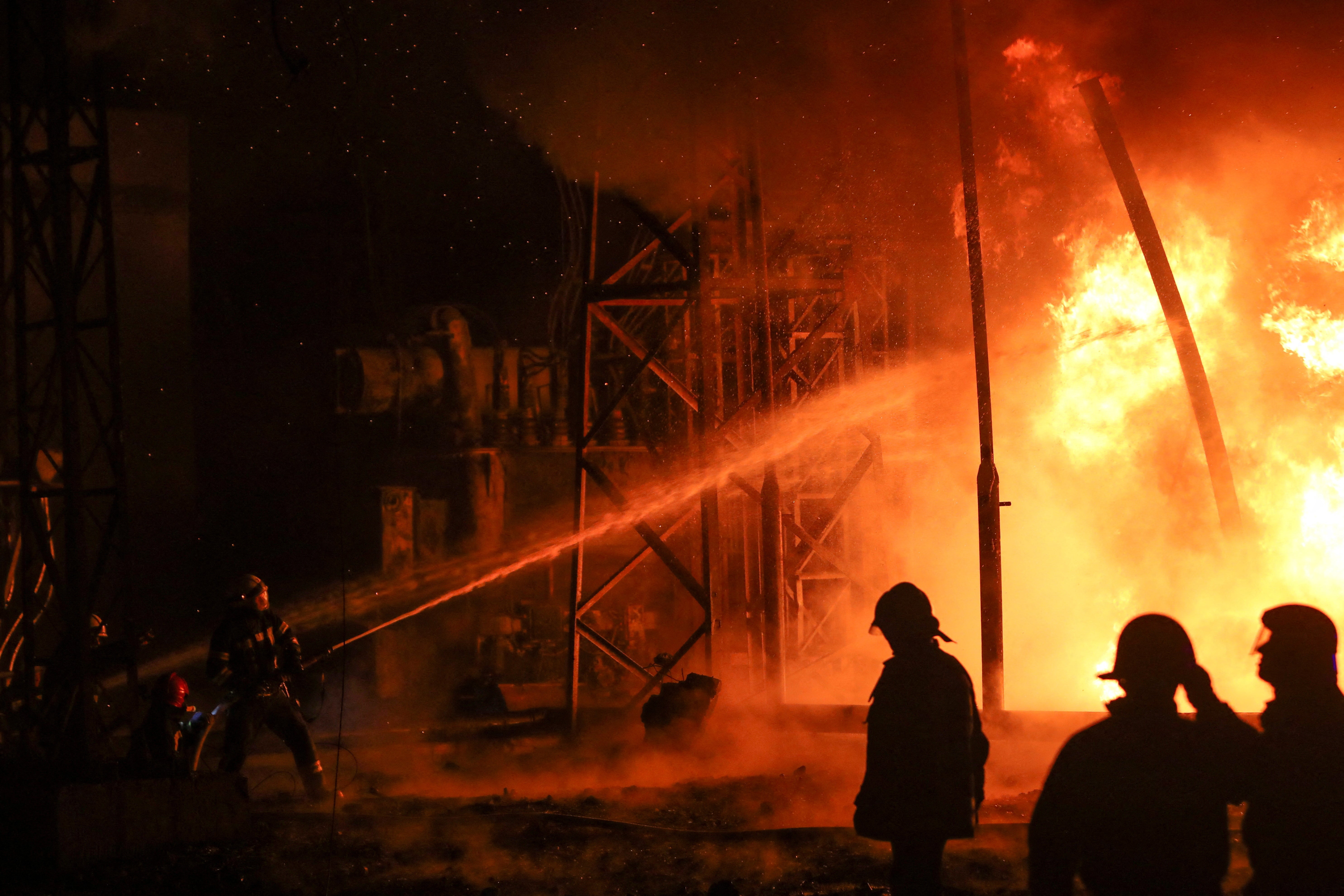 Firefighters work at the site of a power plant damaged by a Russian missile strike in Kharkiv, Ukraine on Sunday