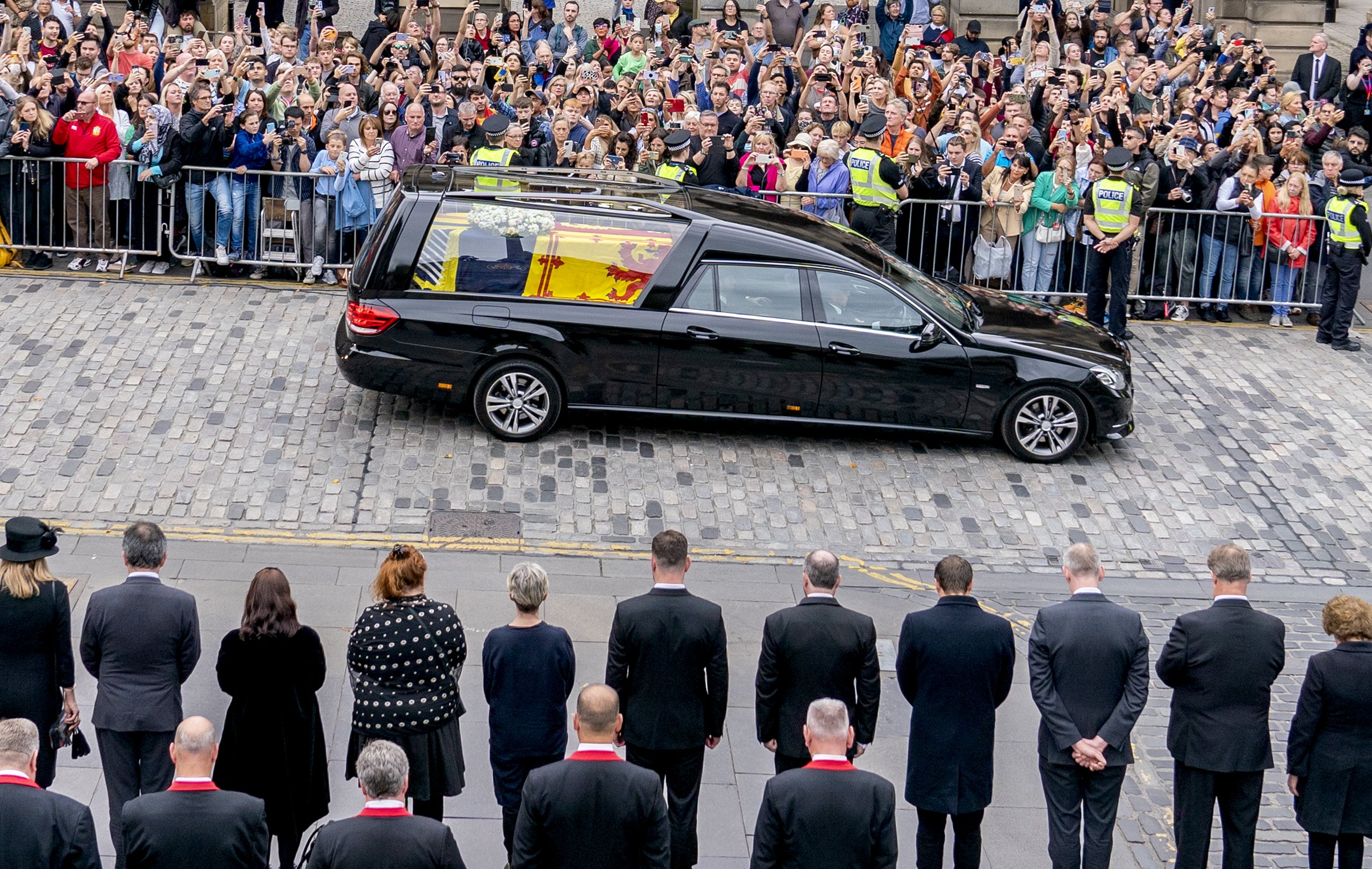 The hearse carrying the coffin of Queen Elizabeth II passes the City Chambers in Edinburgh on its journey from Balmoral to the Palace of Holyroodhouse (Jane Barlow/PA)