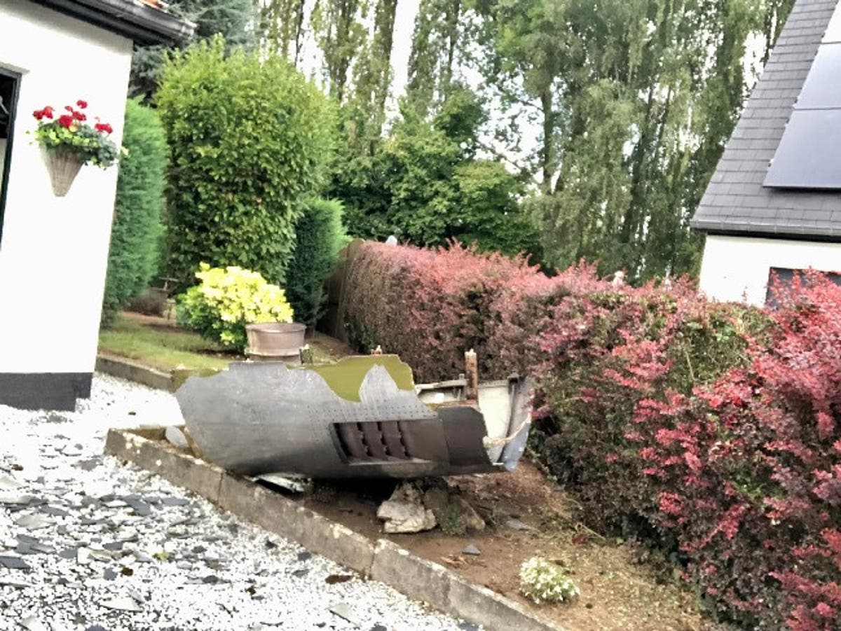 Couple shocked as 747 plane engine falls through shed roof