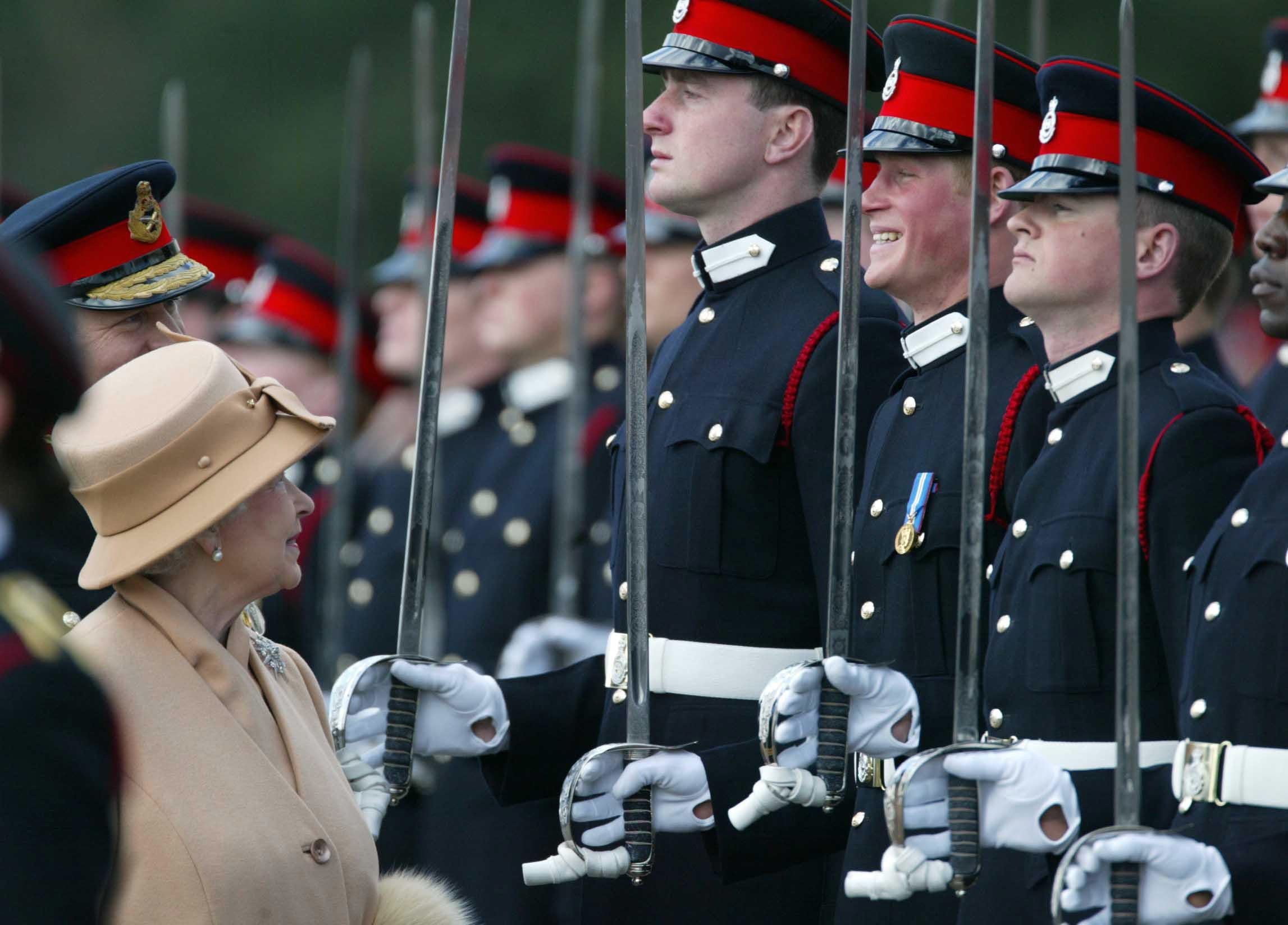 Harry smiling broadly as his grandmother the Queen reviewed him and other officers during the Sovereign’s Parade in 2006 (James Vellacott/PA)