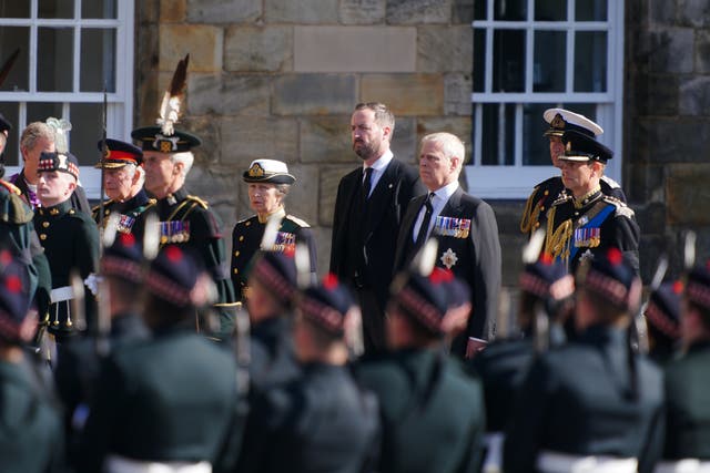 The King (second left), the Princess Royal (centre), the Duke of York (second right) and the Earl of Wessex (right) watch as their mother’s coffin is removed from the Palace of Holyroodhouse (Jon Super/PA)