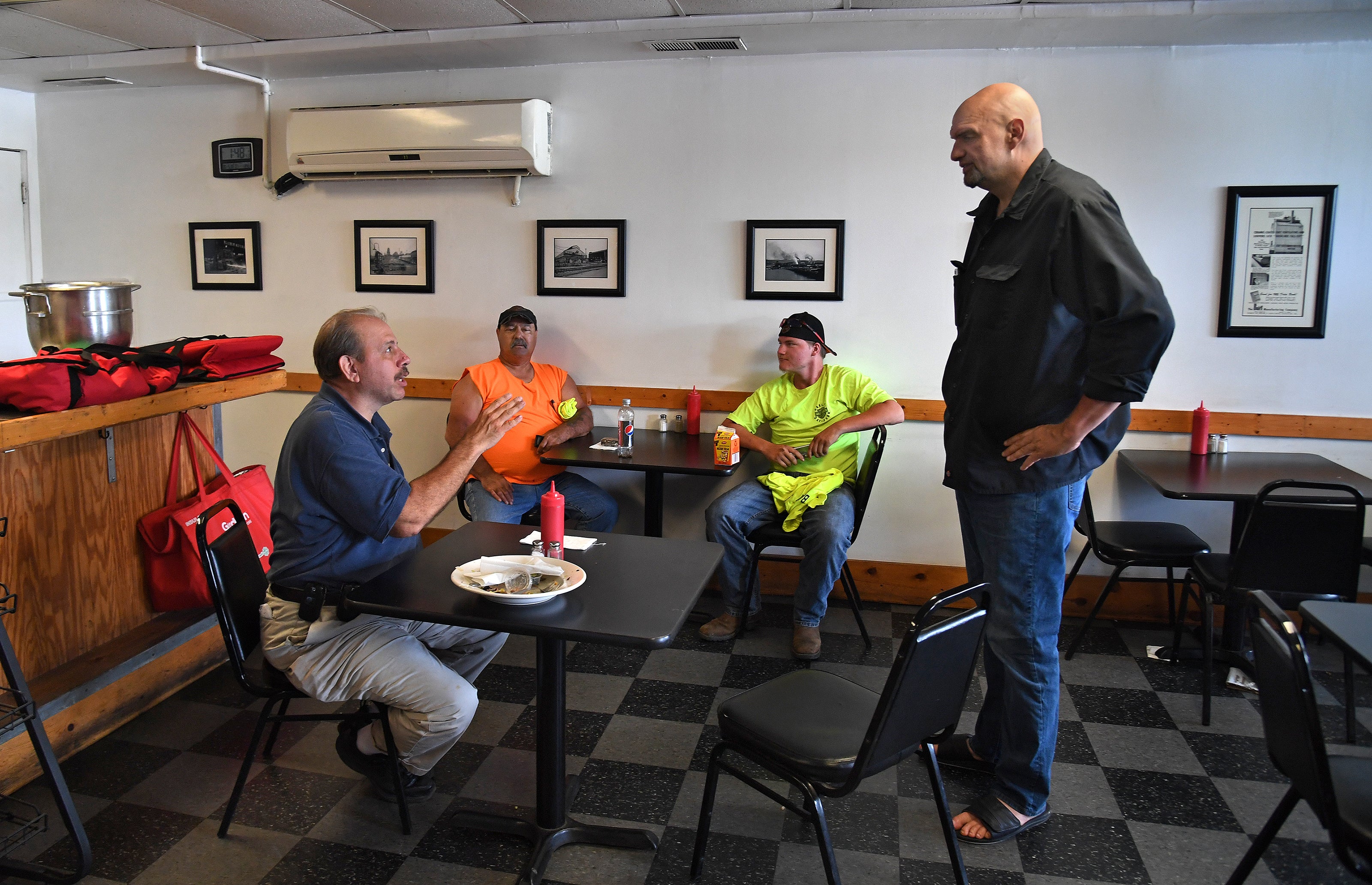 Mayor John Fetterman strikes up a conversation with (L) Chuck Shoaf at a diner in the town of Clairton, Pennsylvania, on June 10, 2018.