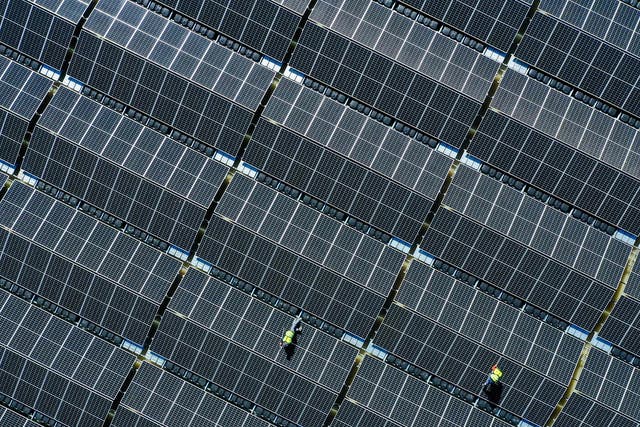 <p>An aerial view shows solar panels at a floating photovoltaic plant on the Silbersee lake in Haltern, Germany’s largest floating solar park, on 22 April, 2022</p>