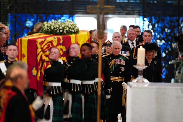 The King and his Queen Consort follow the coffin as they enter St Giles’ Cathedral (Jane Barlow/PA)