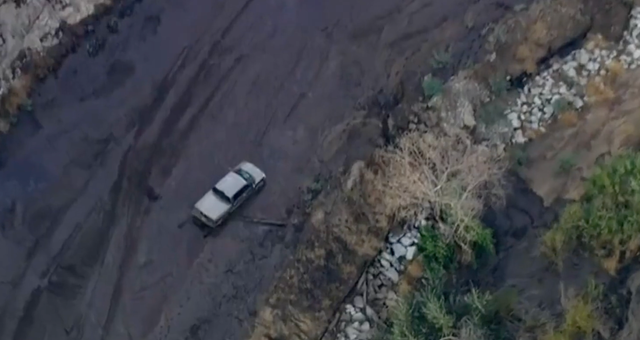 <p>A car is stuck in the mud after mudslides in northern Los Angeles County</p>