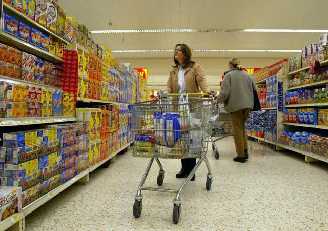 <p>Consumers are now paying a record £571 more on average for their groceries than last year, new figures show (Martin Rickett/PA)</p>