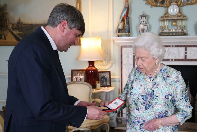 <p>Poet Laureate Simon Armitage with the Queen at Buckingham Palace in May 2019 </p>