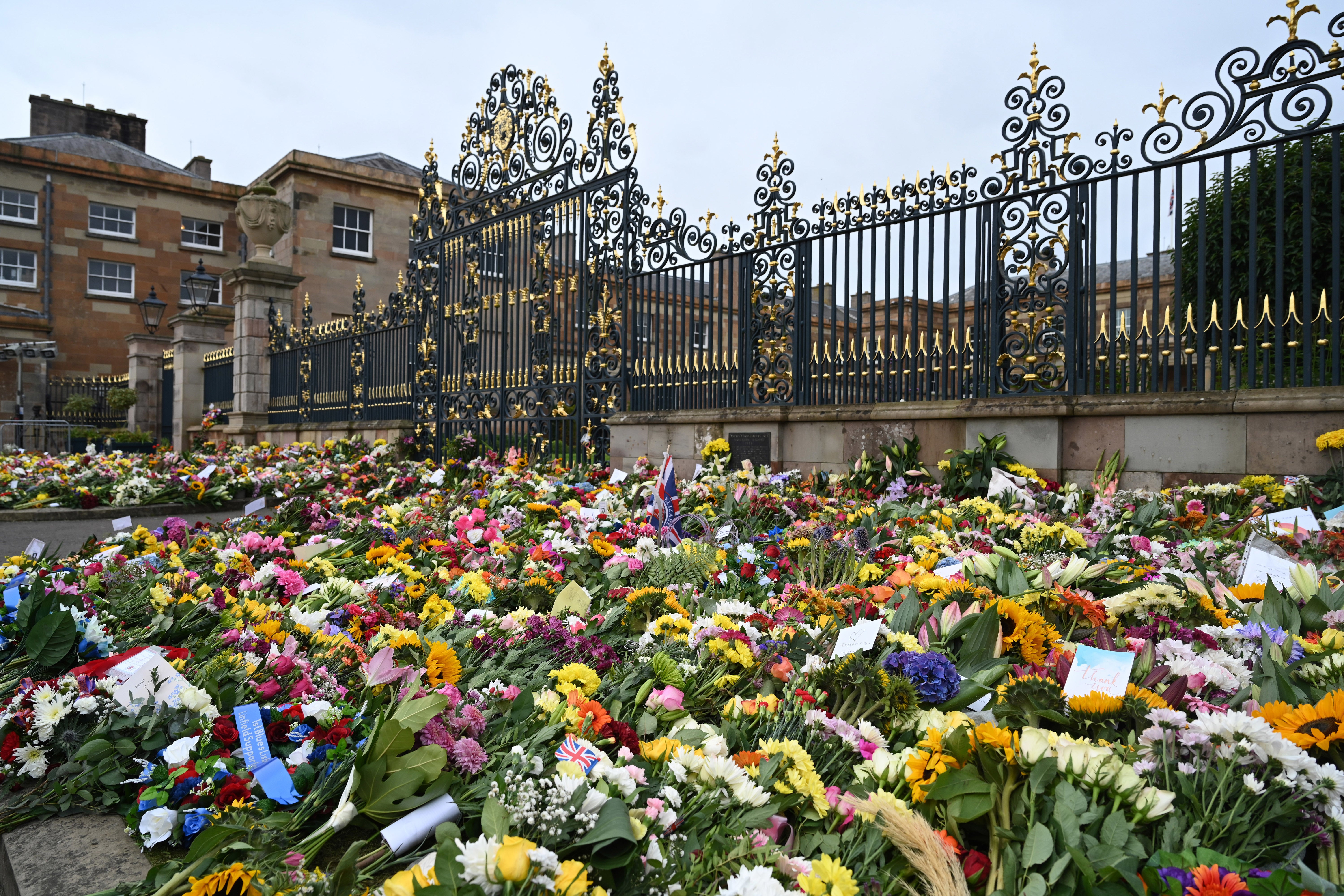 Floral tributes to the Queen outside Hillsborough Castle, Co Down, Northern Ireland ahead of a visit by King Charles III and the Queen Consort (PA)