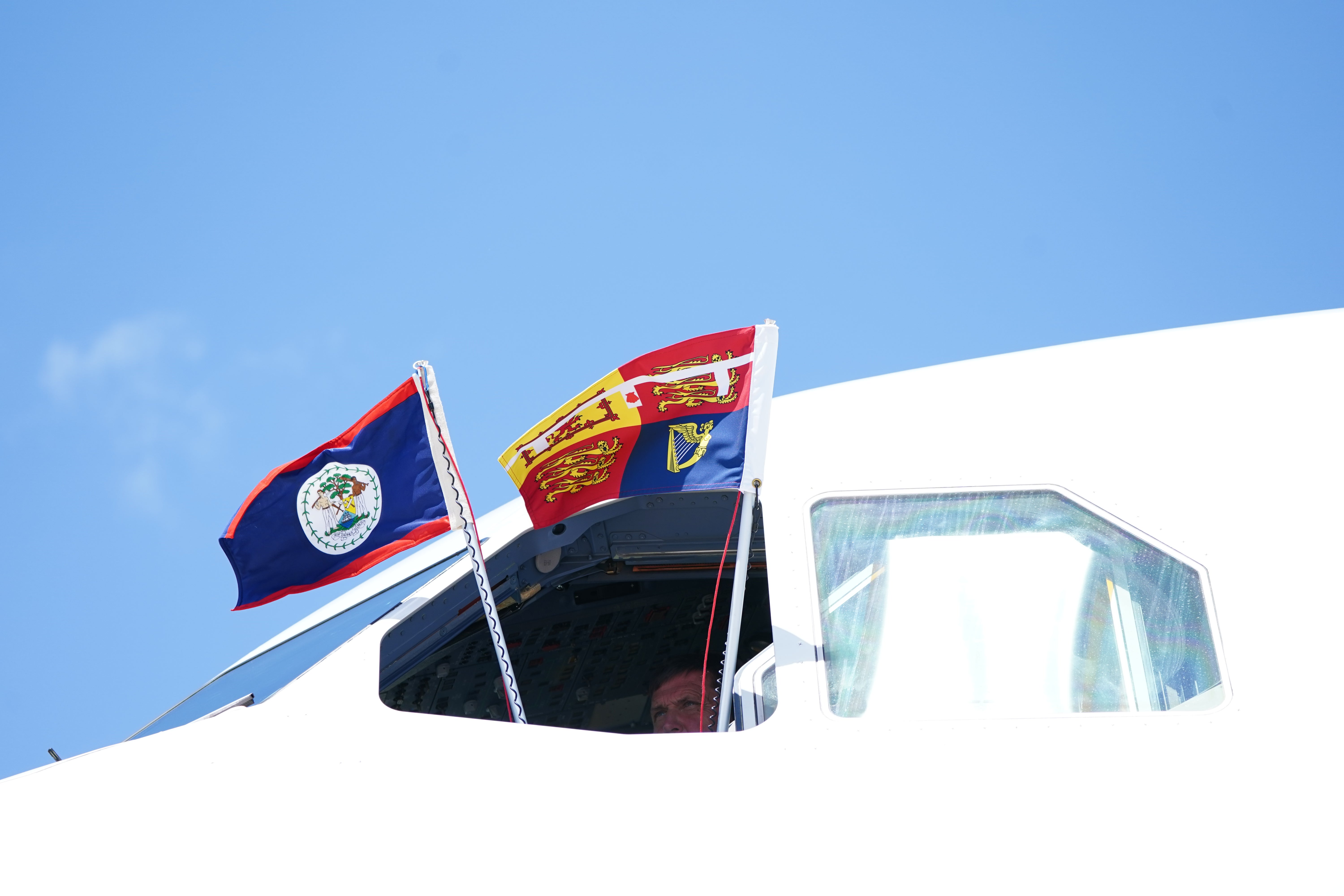 The Royal Standard and the flag of Belize are flown from the window of the cockpit ahead of the departure of the then Duke and Duchess of Cambridge from Belize in March (Jane Barlow/PA)