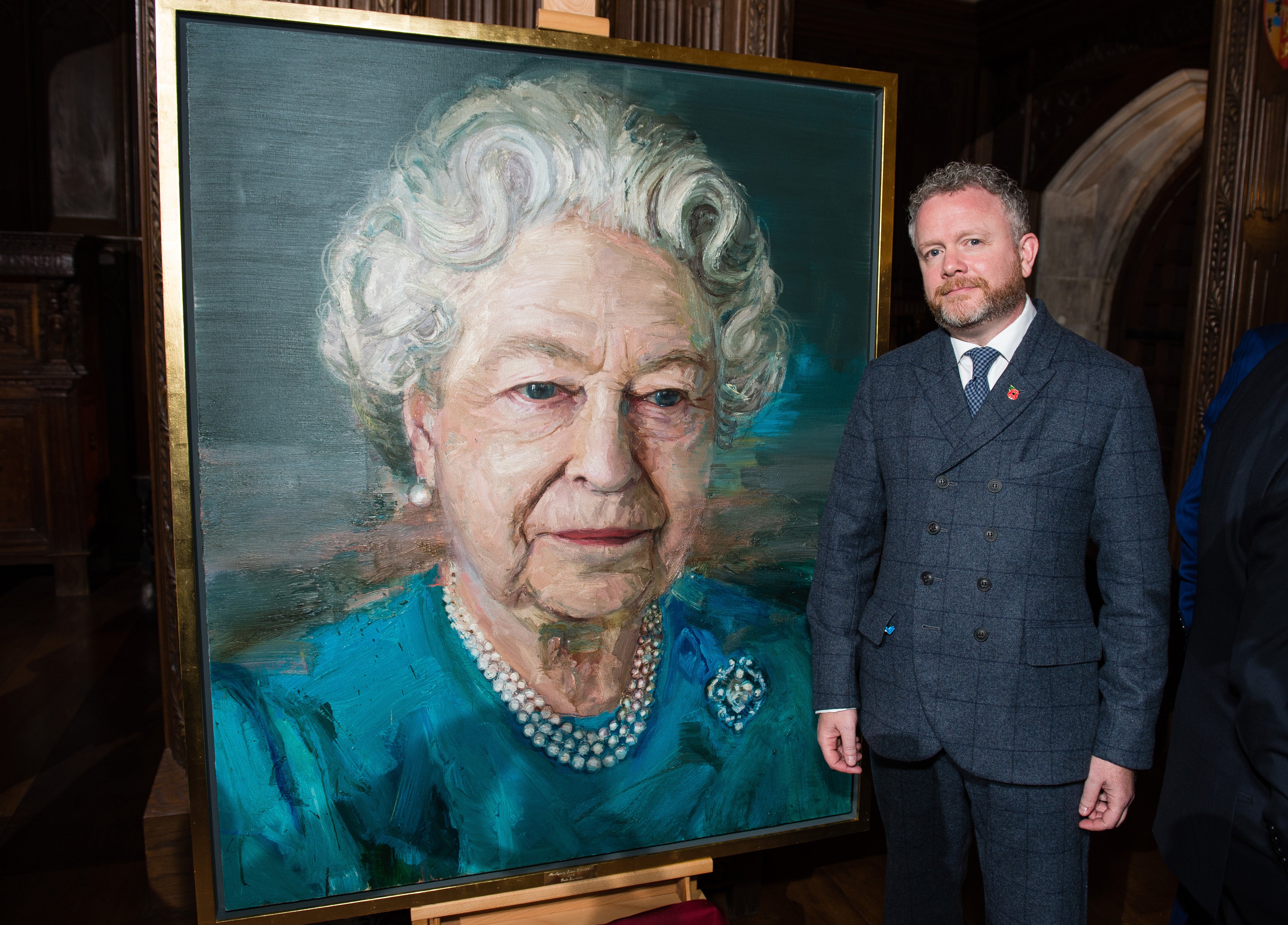 Artist Colin Davidson with his portrait of the Queen displayed at a Co-operation Ireland reception (Jeff Spicer/PA)