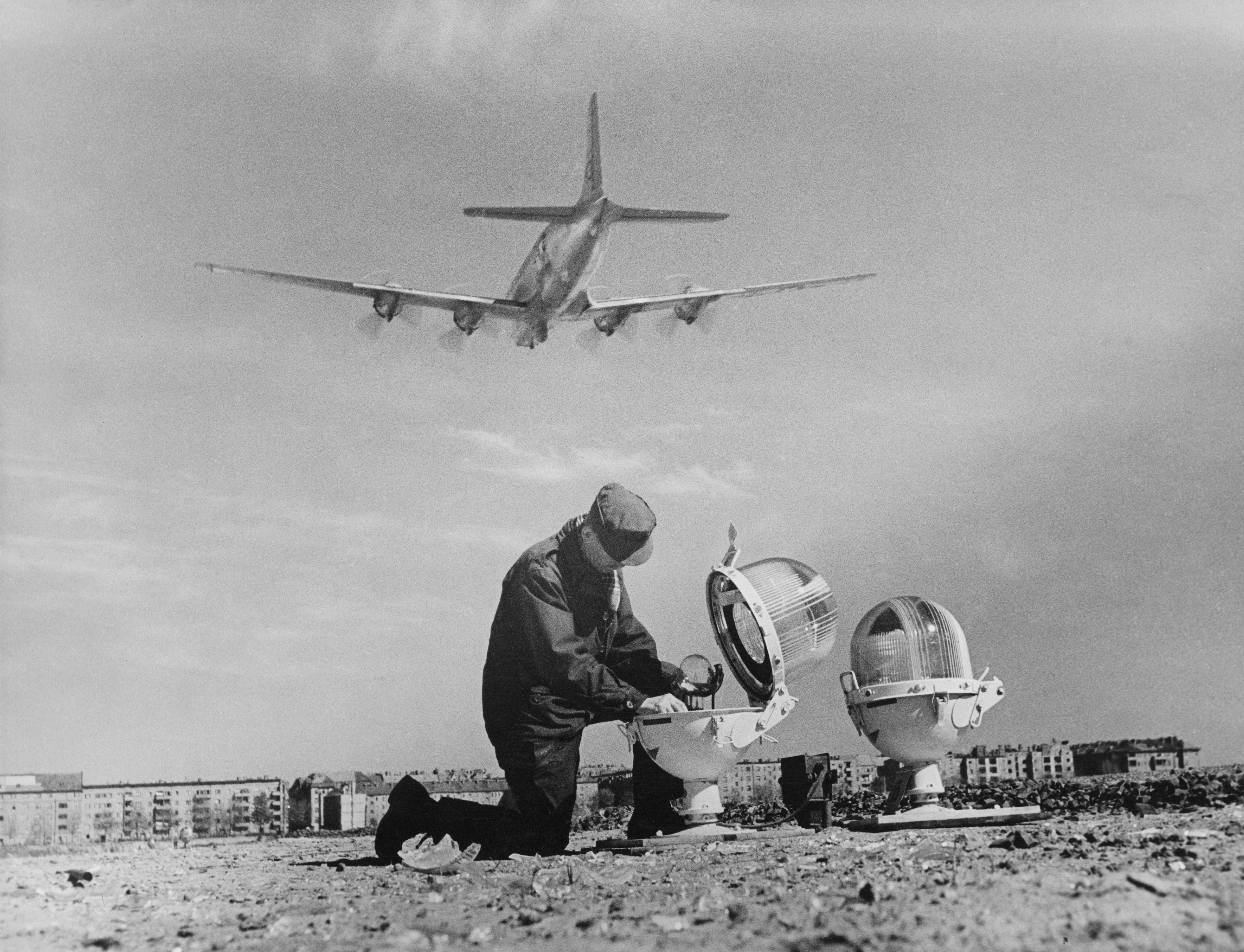 An engineer repairs a landing light at Tempelhof Airport during the Berlin Airlift in April 1949