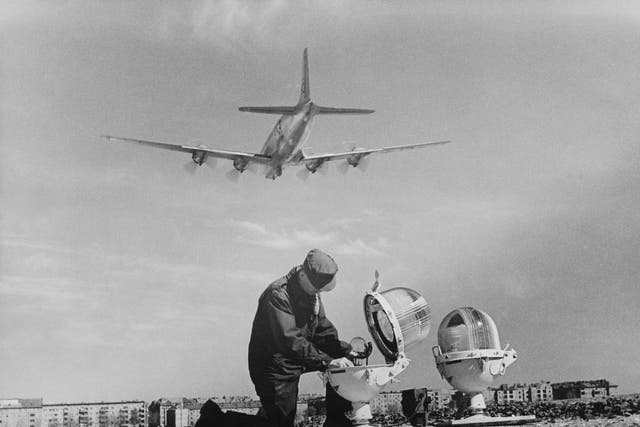 <p>An engineer repairs a landing light at Tempelhof Airport during the Berlin Airlift in April 1949</p>