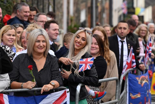 Members of the public gather outside Hillsborough Castle, Co Down, Northern Ireland ahead of a visit by King Charles III and the Queen Consort following the death of Queen Elizabeth II (Niall Carson/PA)
