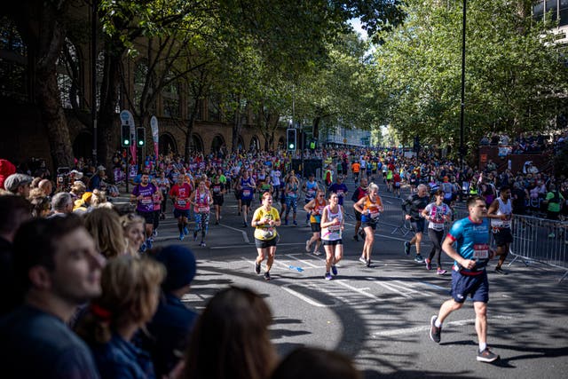 <p>Runners on The Highway as they take part in the London Marathon at Tower Bridge</p>