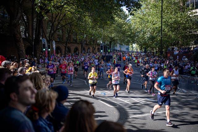 <p>Runners on The Highway as they take part in the London Marathon at Tower Bridge</p>