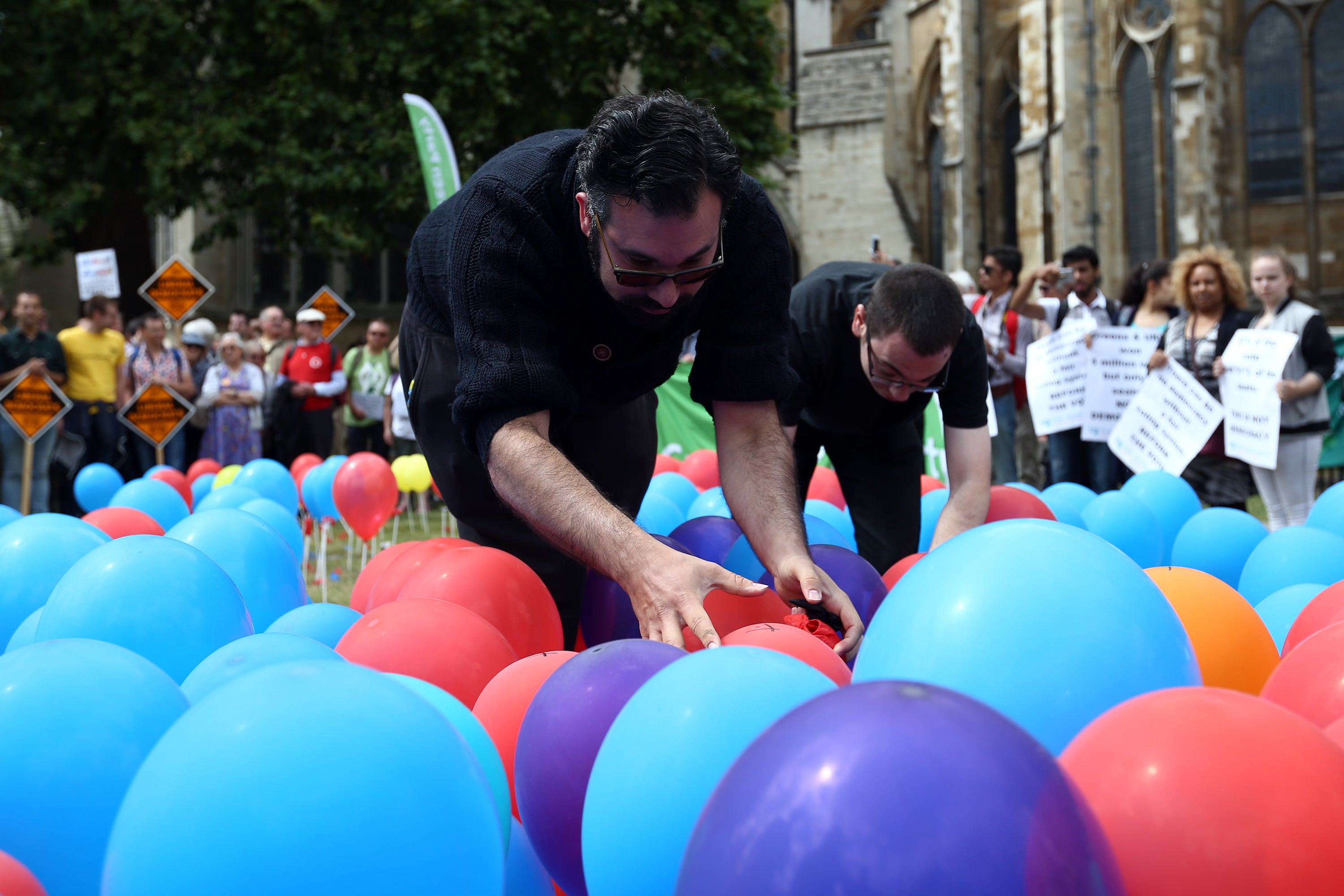 Supporters of PR burst balloons to highlight the perceived lack of fairness in the voting system