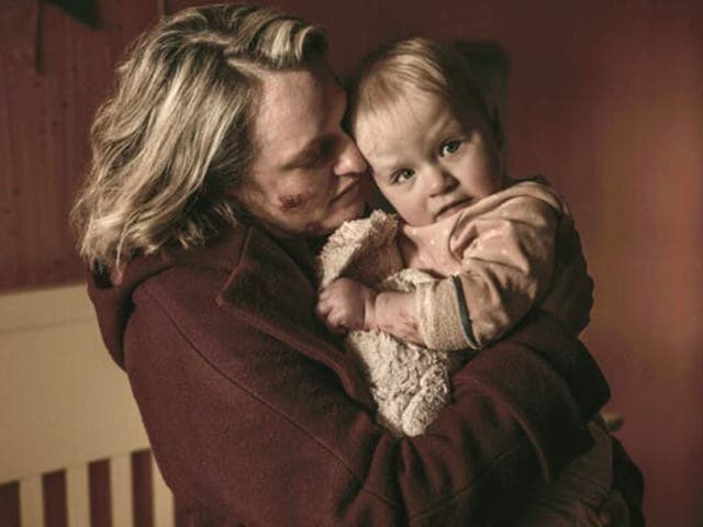 <p>June Osborne (Elisabeth Moss) returns home to see her baby daughter</p>