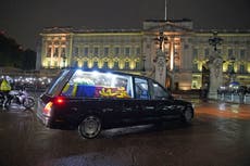 Queen arrives at Buckingham Palace as Harry and Meghan join royals to receive coffin