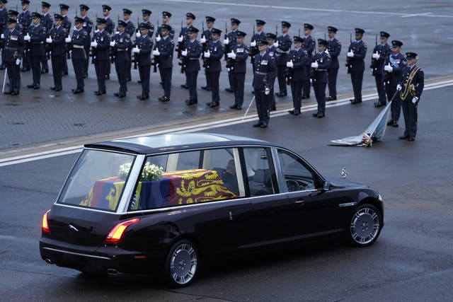 The hearse carrying the coffin of Queen Elizabeth II departs RAF Northolt, west London (PA)