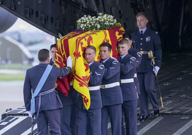 <p>The bearer party from the Queen’s Colour Squadron carry the Queen’s coffin to the state hearse (Arthur Edwards/The Sun)</p>