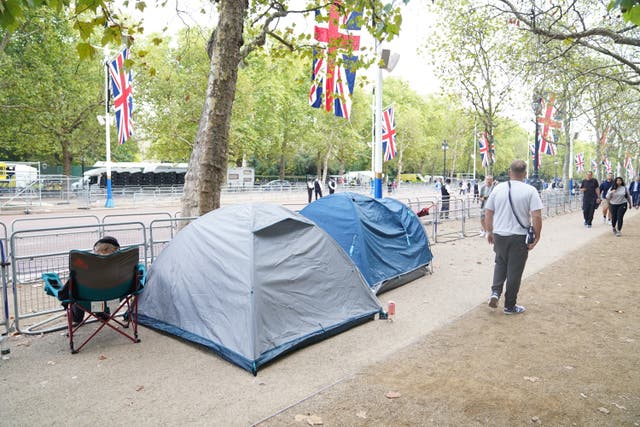 People have already started to camp on The Mall, in London, ahead of the Queen’s coffin being taken from Buckingham Palace on Wednesday afternoon to the Palace of Westminster (James Manning/PA)