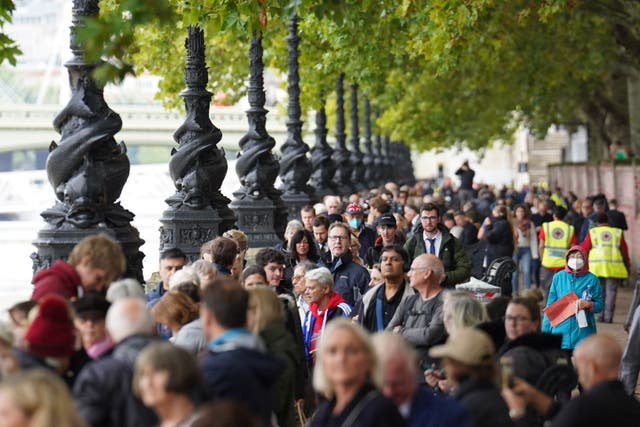 Members of the public join the queue on the South Bank as they wait to view Queen Elizabeth II lying in state (Stefan Rousseau/PA)