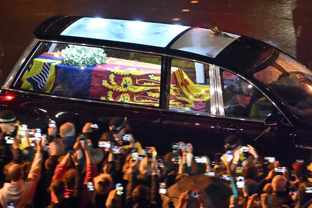 <p>Seen from the top of the Wellington Arch, the coffin of Queen Elizabeth II is taken in a royal hearse to Buckingham Palace to lie at rest overnight in the Bow Room on September 13, 2022</p>