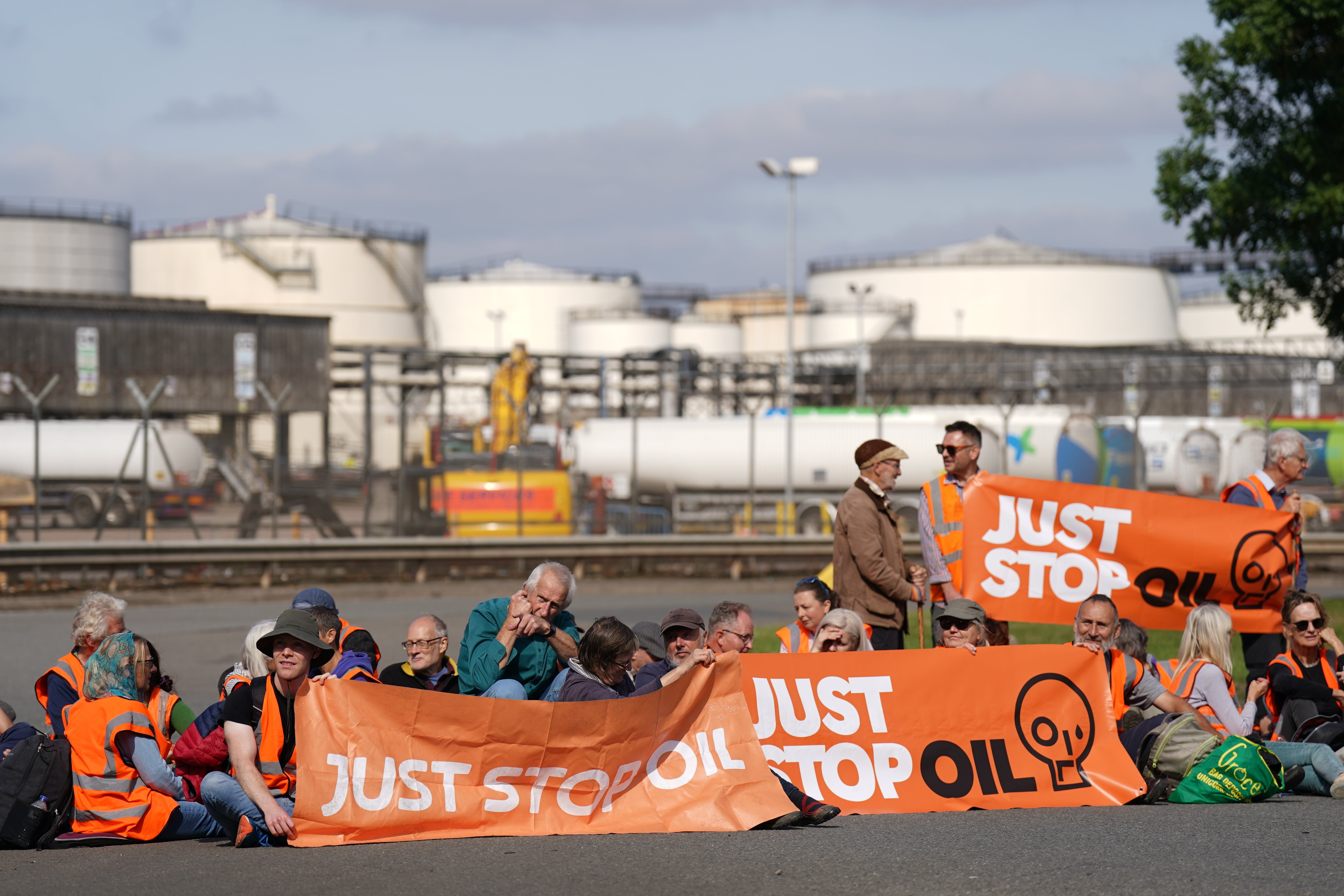 People take part in a Just Stop Oil protest blocking the entrance to the Kingsbury Oil Terminal near Birmingham (Joe Giddens/PA)