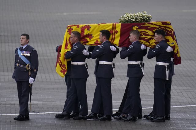 The coffin of Queen Elizabeth II is carried to the waiting hearse at RAF Northolt, west London, from where it will be taken to Buckingham Palace, London, to lie at rest overnight in the Bow Room (Andrew Matthews/PA)