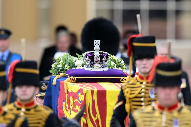 The coffin of the Queen, draped in the Royal Standard with the Imperial State Crown placed on top, is carried on a horse-drawn gun carriage (Daniel Leal/PA)