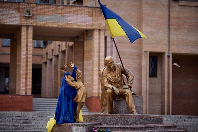 <p>Decorated figure: a monument for Ukrainian writer and politician Taras Shevchenko is seen draped with the Ukrainian flag in Balakliya after Russian forces were driven out</p>