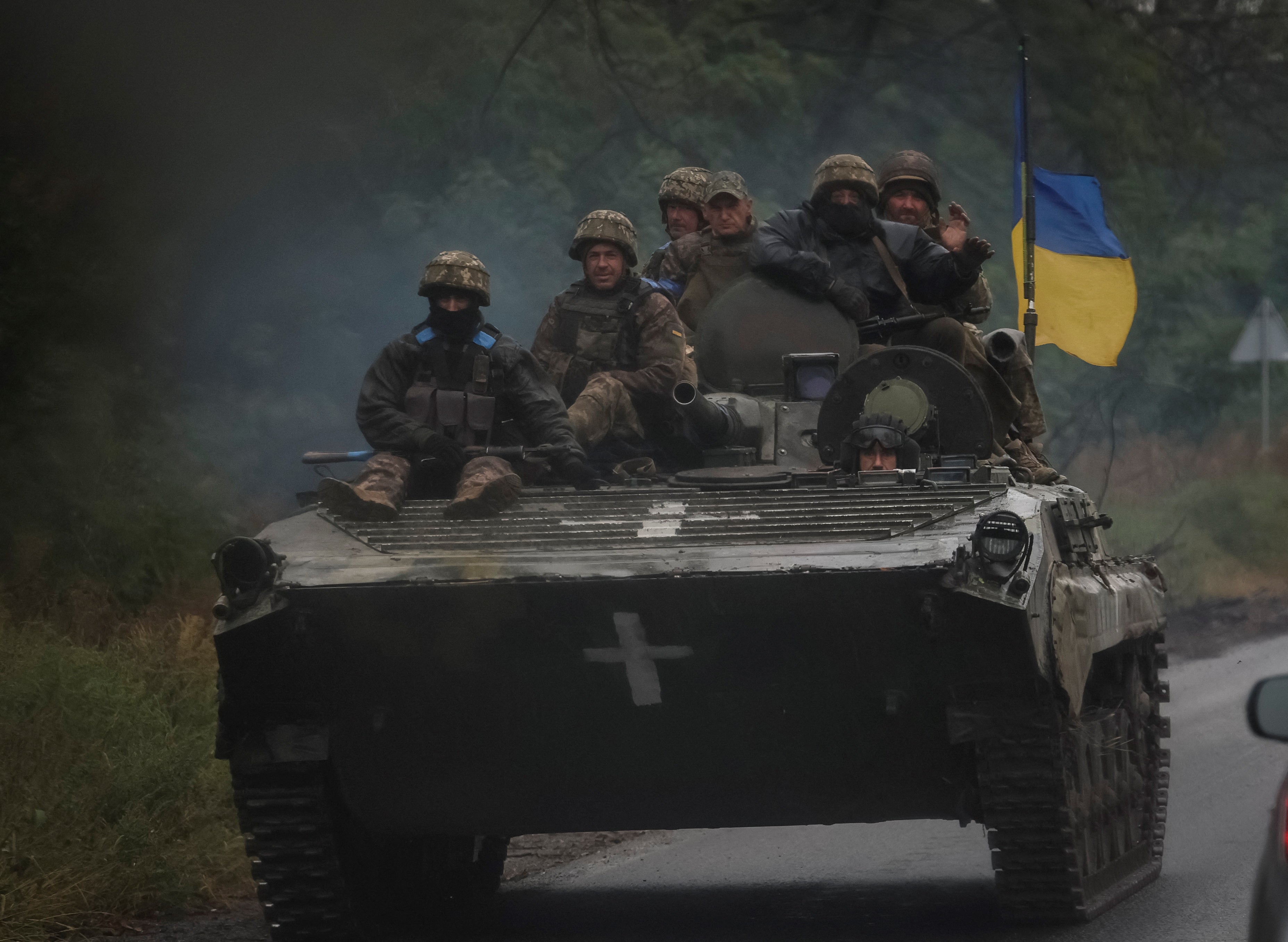 Ukrainian soldiers drive near Izium, Kharkiv region.