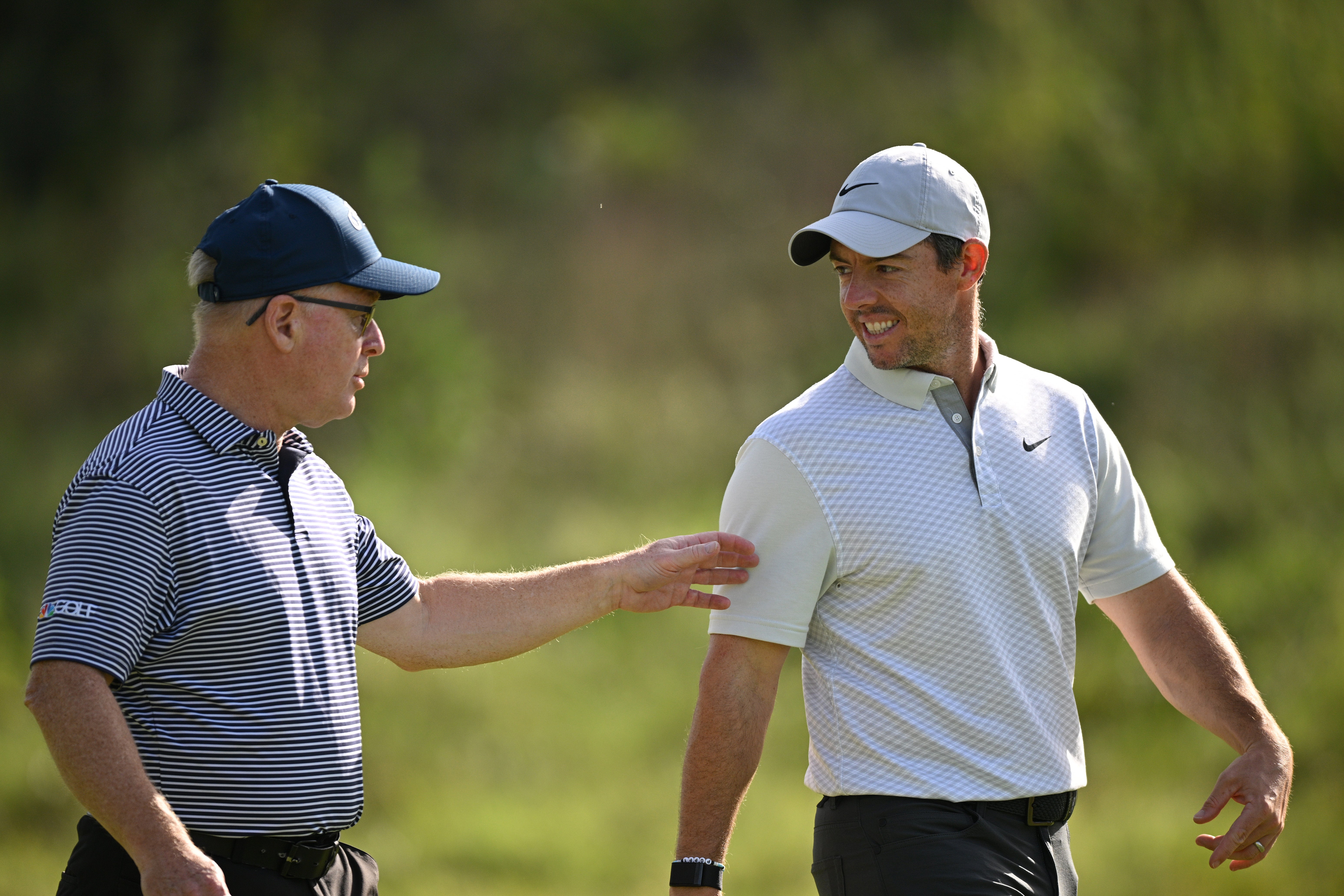 Rory McIlroy of Northern Ireland talks with Keith Pelley, CEO of the DP World Tour