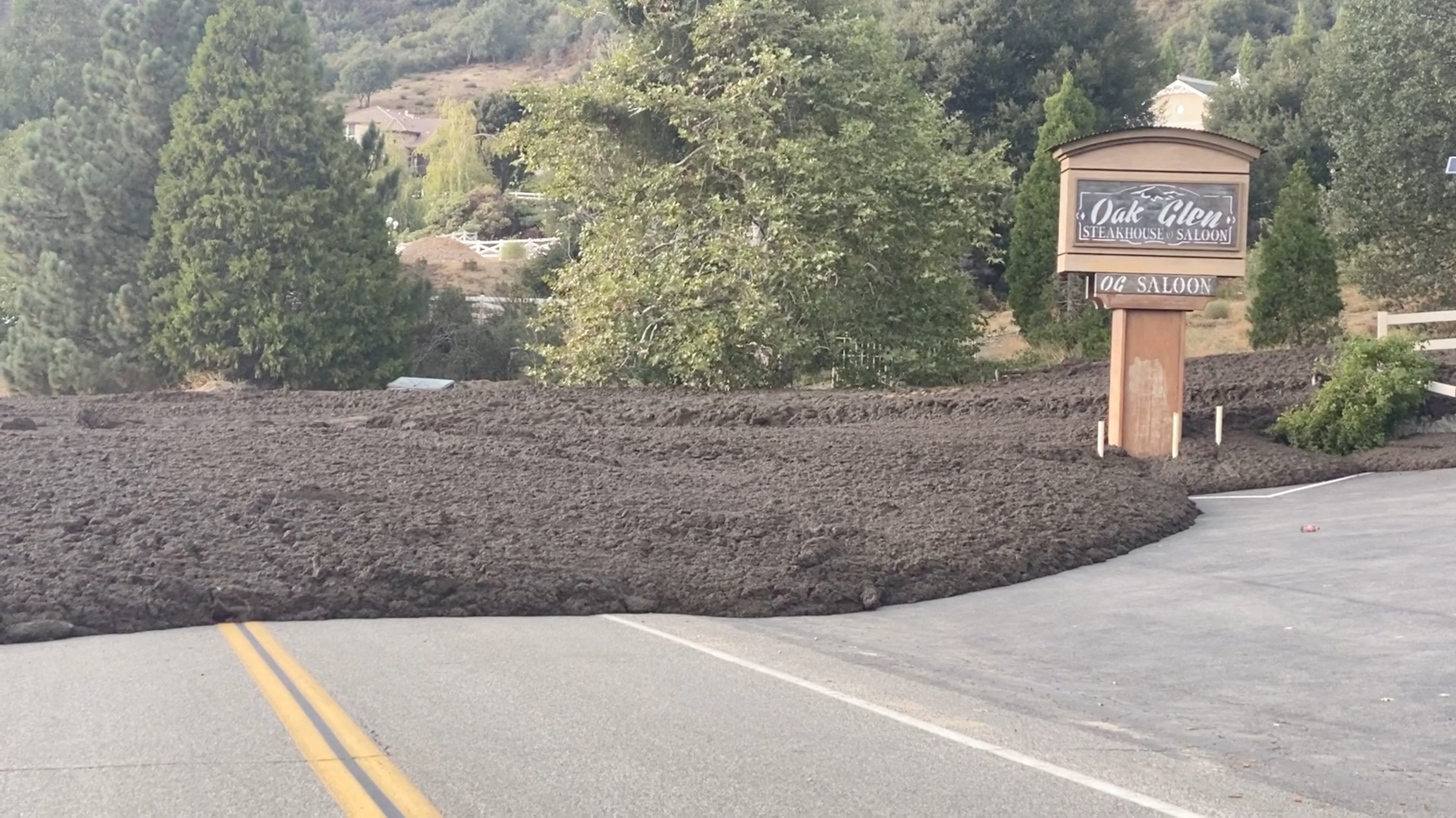 <p>A mudslide surrounds a restaurant in Oak Glen, California on Monday</p>