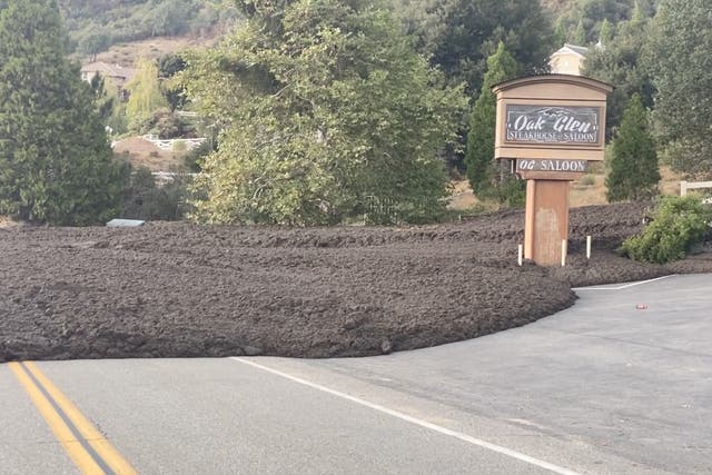 <p>A mudslide surrounds a restaurant in Oak Glen, California on Monday</p>