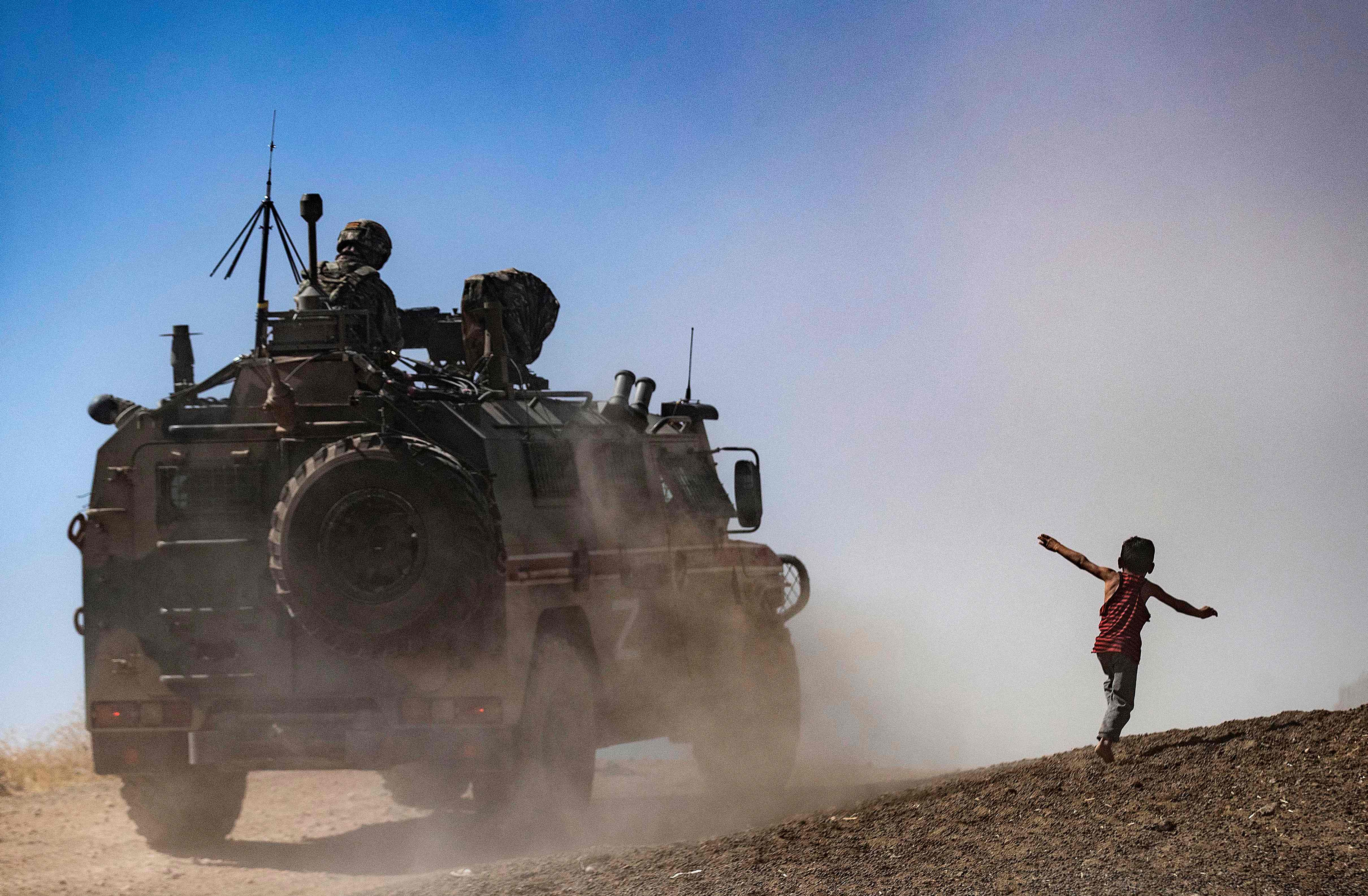 Military vehicles are pictured during a joint Russian-Turkish patrol in the eastern countryside of the town of Darbasiyah near the border with Turkey in Syria's northeastern Hasakah province