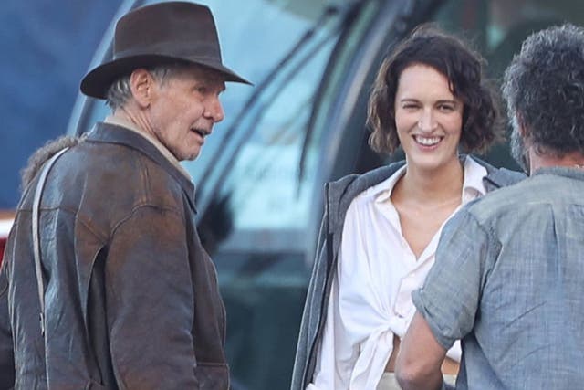 <p>Harrison Ford and Phoebe Waller-Bridge on the set of ‘Indiana Jones 5’ – the film is out next summer</p>