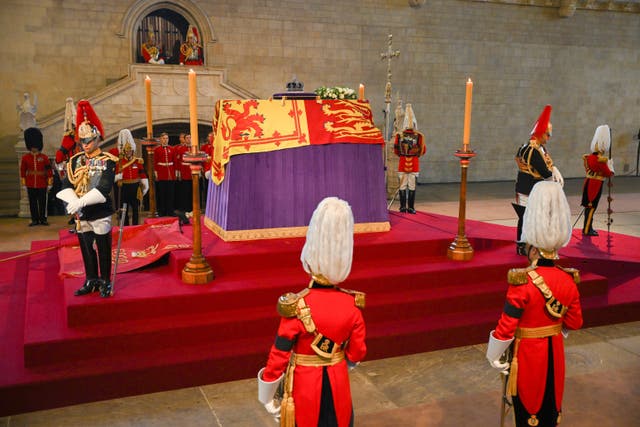 The Queen’s coffin, draped in the Royal Standard with the Imperial State Crown placed on top, lays on the catafalque in Westminster Hall (David Ramos/PA)