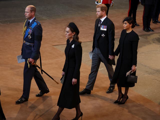 <p>Prince Harry and Meghan Markle hold hands as they exit Westminster Hall service</p>