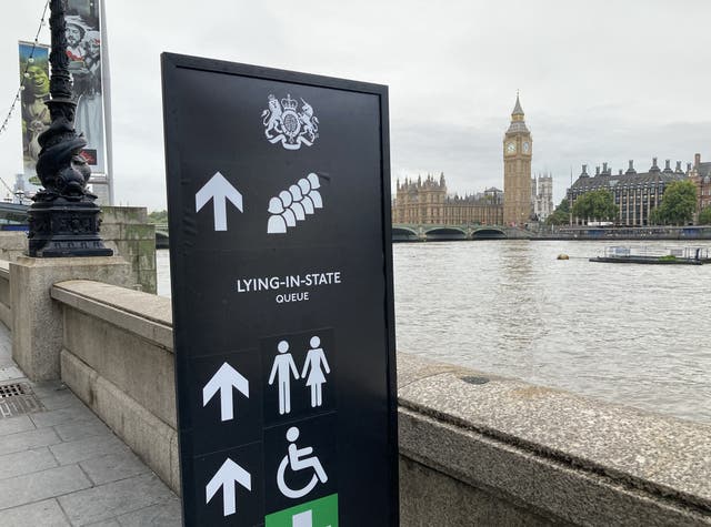 Signage on the South Bank, London, for members of the public to wait in the queue to view Queen Elizabeth II lying in state ahead of her funeral on Monday. (David Hughes/PA)