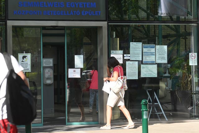 <p>A woman walks into the Obstetrics Clinic of Semmelweis University in Budapest</p>