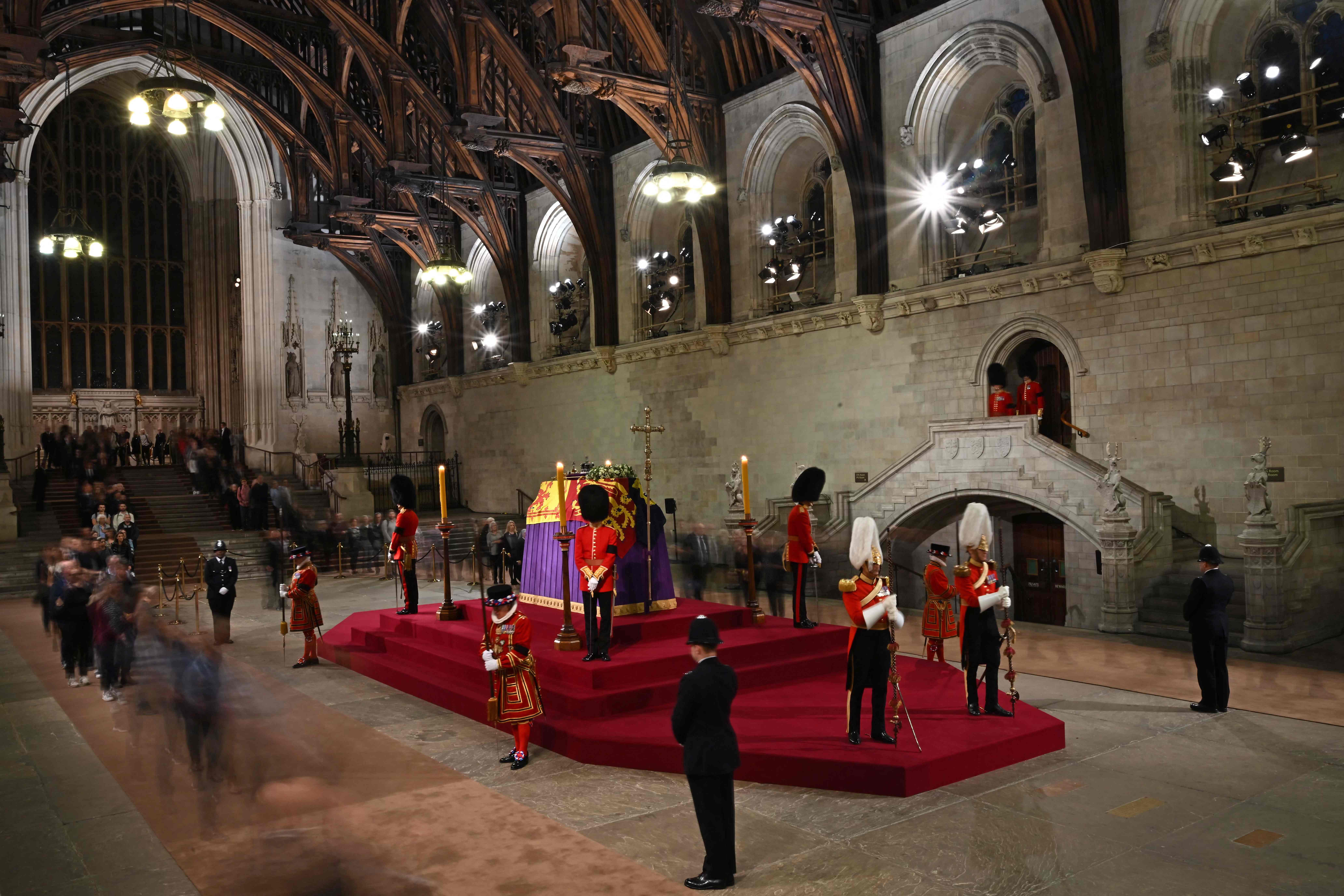 Members of the public file past the coffin of Queen Elizabeth II, inside Westminster Hall,