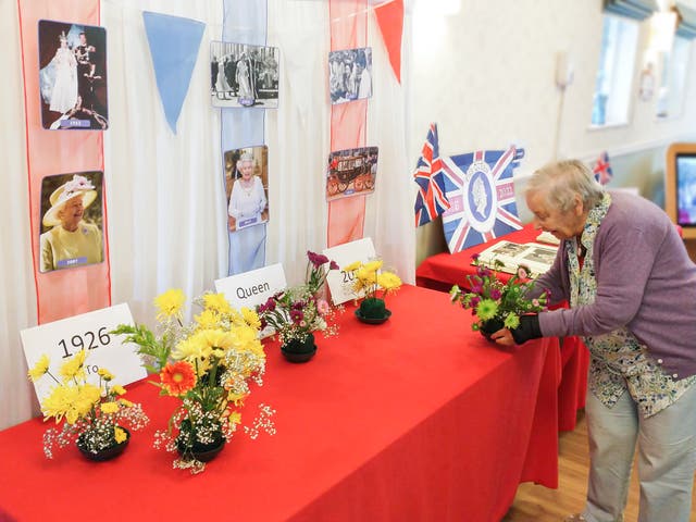 Vera Wren, 90, a resident of The Lawn care home in Alton, Hampshire, where residents have decorated a table with photographs of the Queen, bunting and their own flower arrangements (Friends of the Elderly/PA)