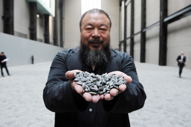<p>Chinese artist Ai Weiwei with his work Sunflower Seeds, at the Tate Modern </p>