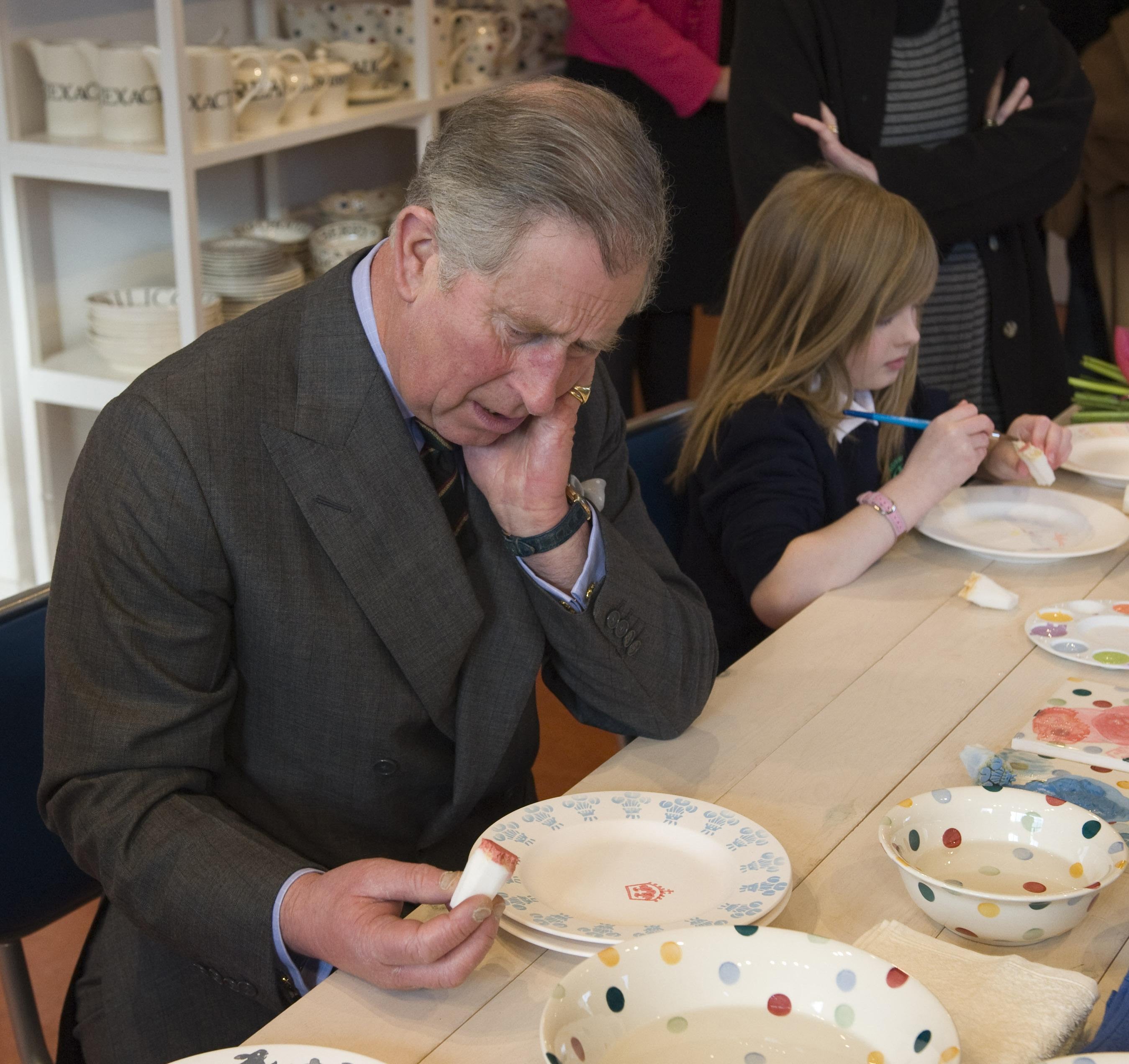 The then Prince of Wales, Charles, taking part in sponge-painting with local schoolchildren, during a previous visit to Emma Bridgewater (Arthur Edwards/The Sun)