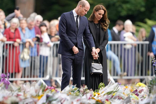 <p>The Prince and Princess of Wales looking at floral tributes at Sandringham House  </p>