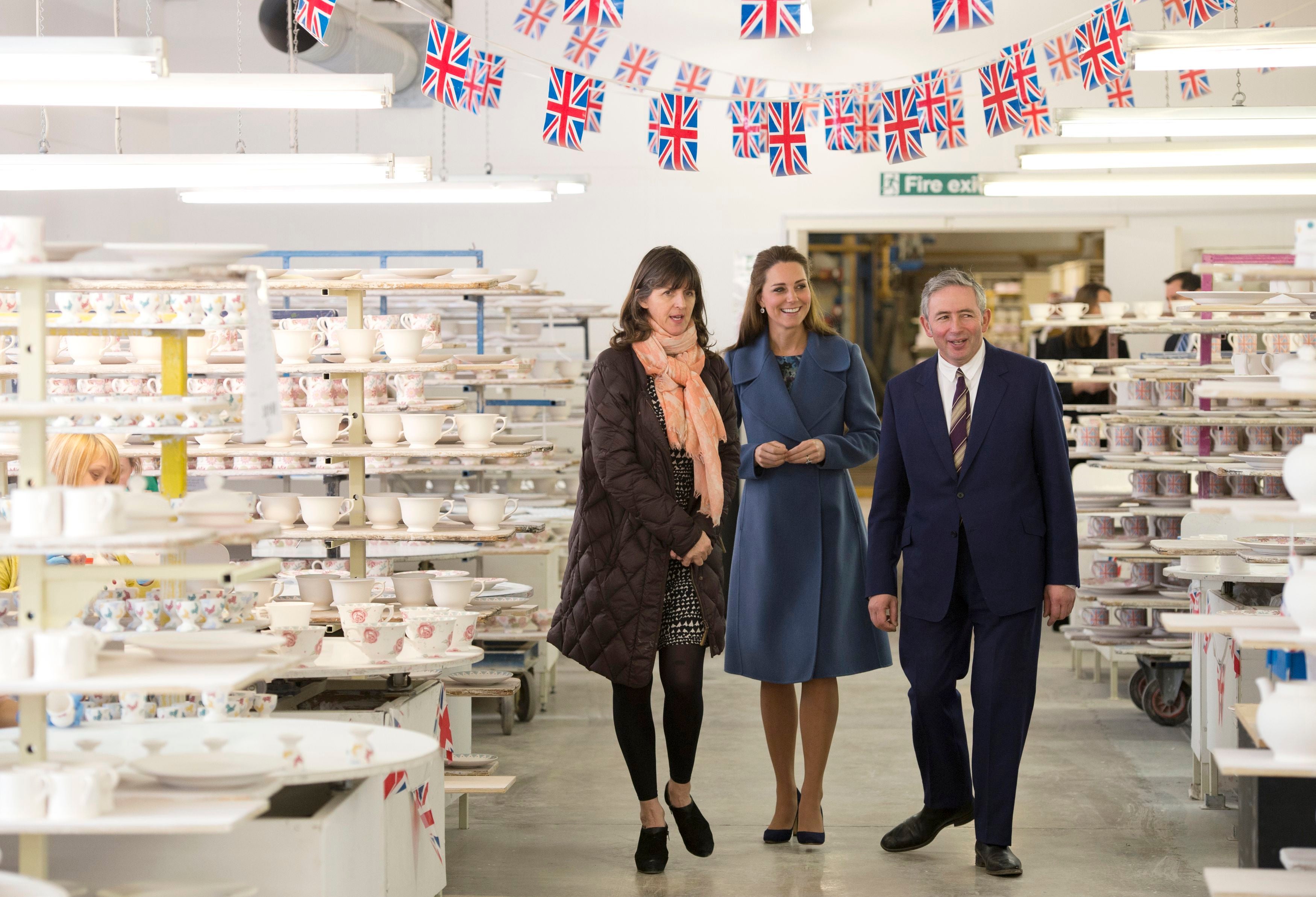 The then Duchess of Cambridge, Kate, walks with Emma Bridgewater and her husband Matthew Rice, during a visit to the factory in 2015 (Oli Scarff/PA)