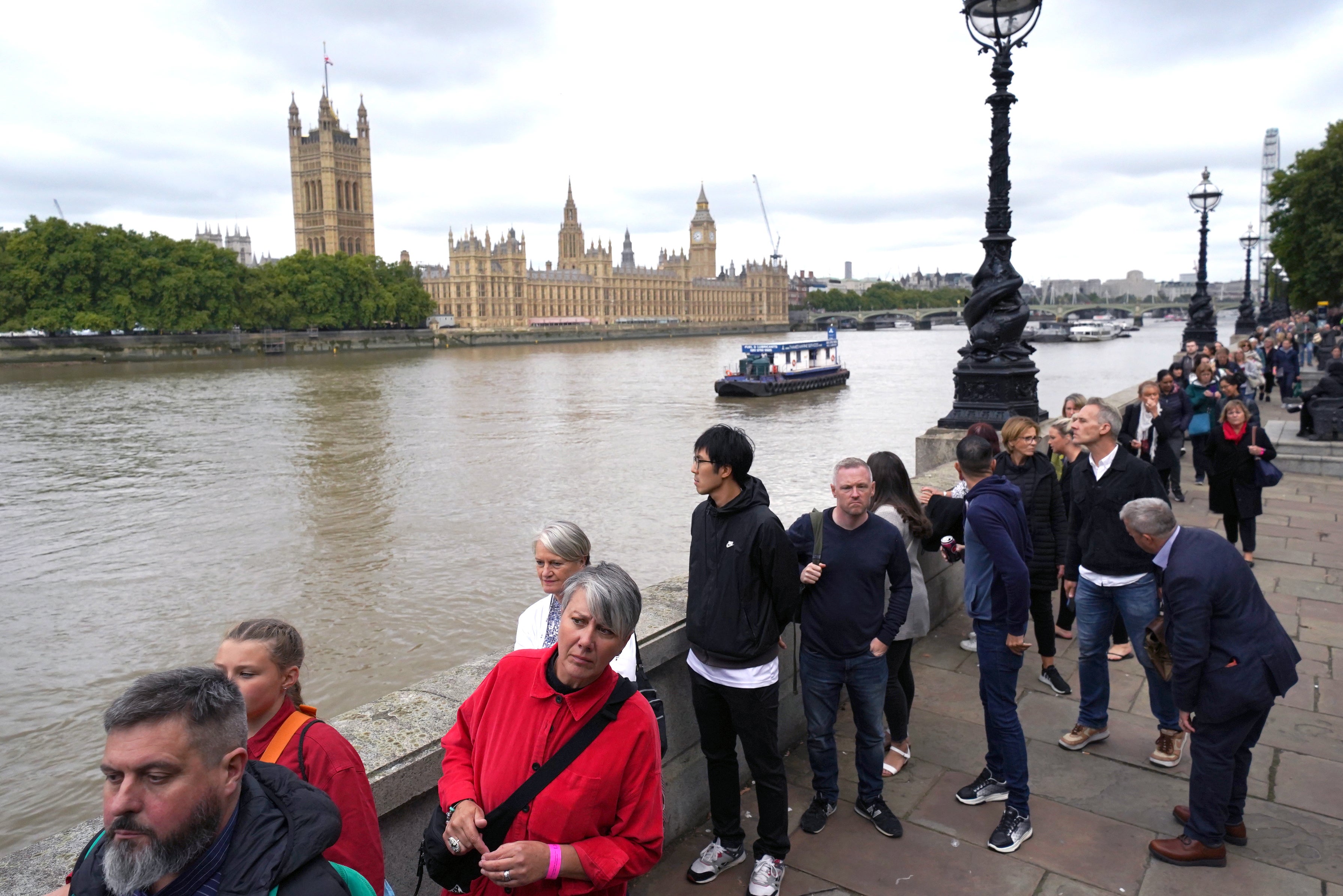 Members of the public in the queue on the South Bank near to Lambeth Bridge as they wait to view the Queen’s lying in state (Jacob King/PA)