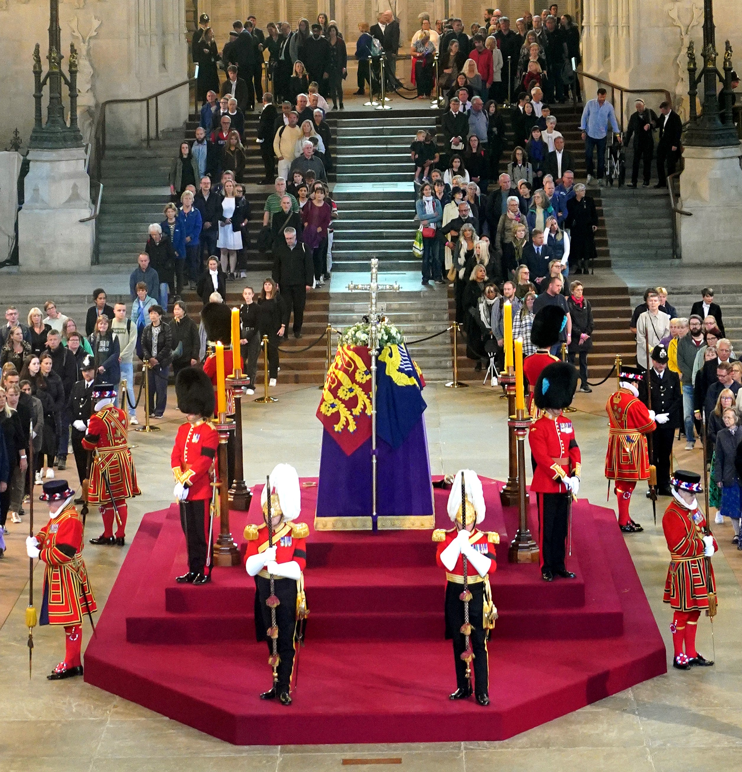 Members of the public file past the coffin of Queen Elizabeth II lying in state on the catafalque in Westminster Hall, at the Palace of Westminster, London, ahead of her funeral on Monday (Yui Mok/PA)